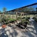 Gravel walking paths between raised vegetable garden beds covered by shade netting